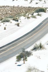 Asphalt road at scenic mountain valley and power line