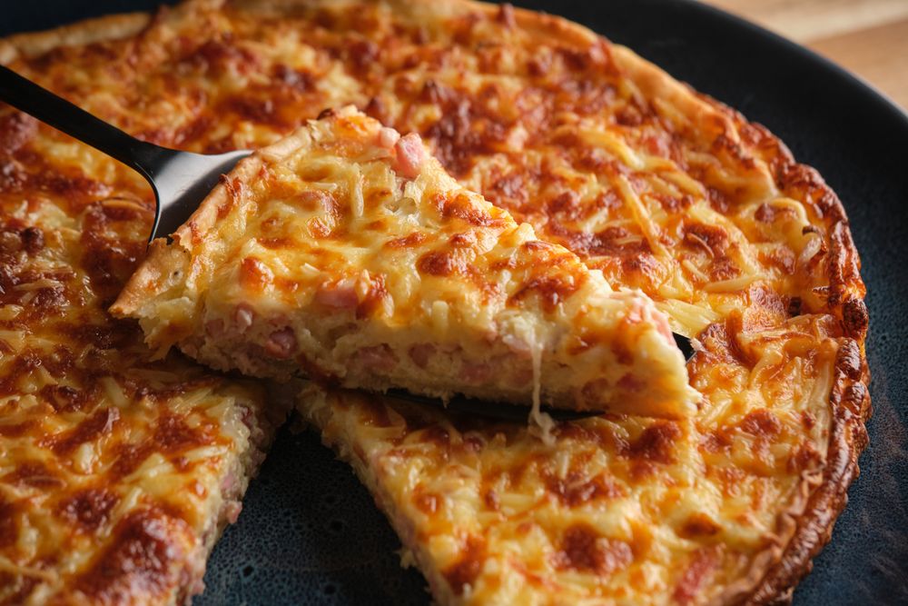 Cheese and bacon quiche on plate