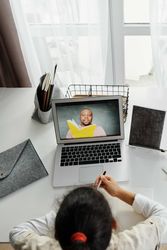Top view of girl attending an online class using computer