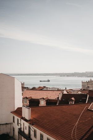 View of buildings roofs and sea