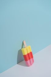 Colorful ice cream popsicle on pastel blue background