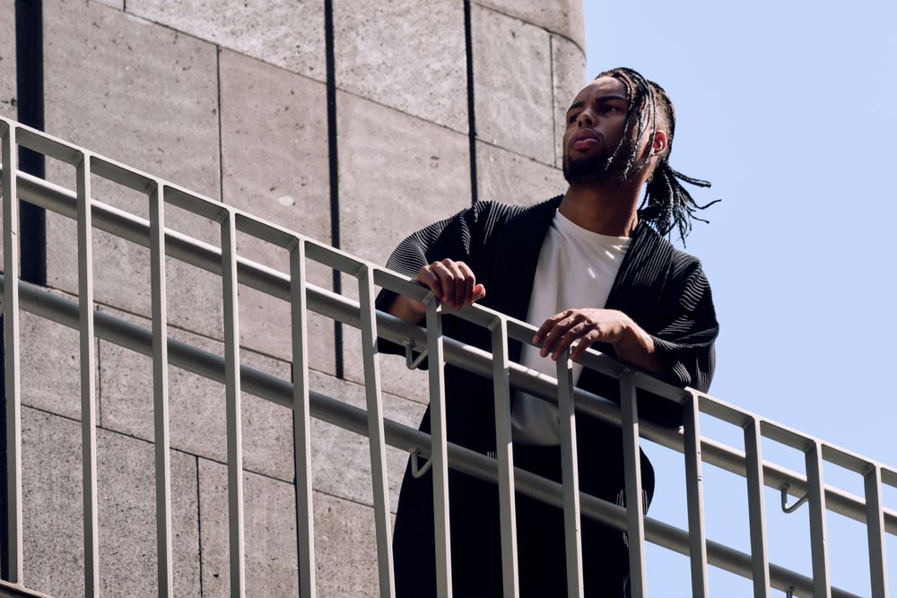 Black male standing on bridge