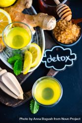 Top view of yellow detox shots with lemon, ginger and mint 5ROdA4