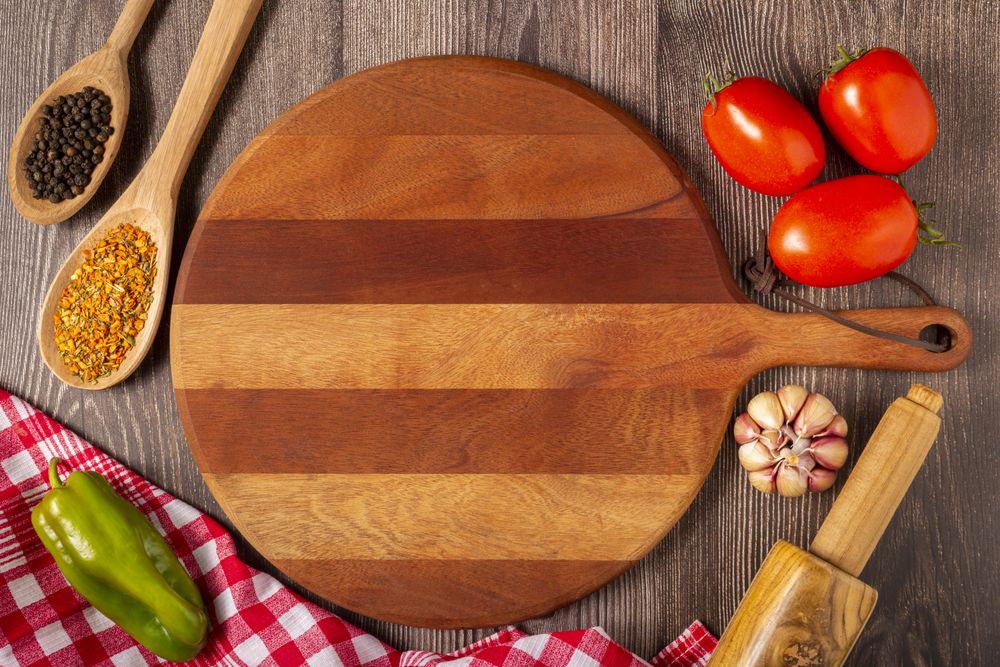 Wooden table with ingredients for pizza.