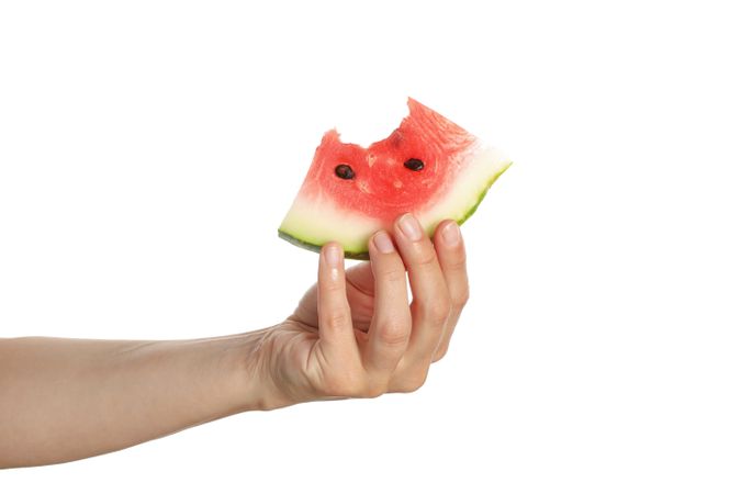 Female hand hold watermelon slice, isolated on plain background