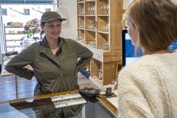 Female gardener talking to female shopkeeper