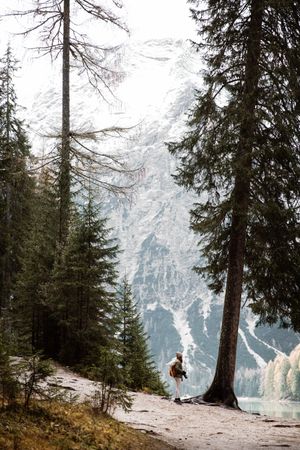 Woman delighting in views near lake and mountains