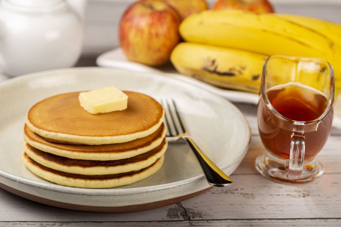 Delicious pancakes with butter and honey.