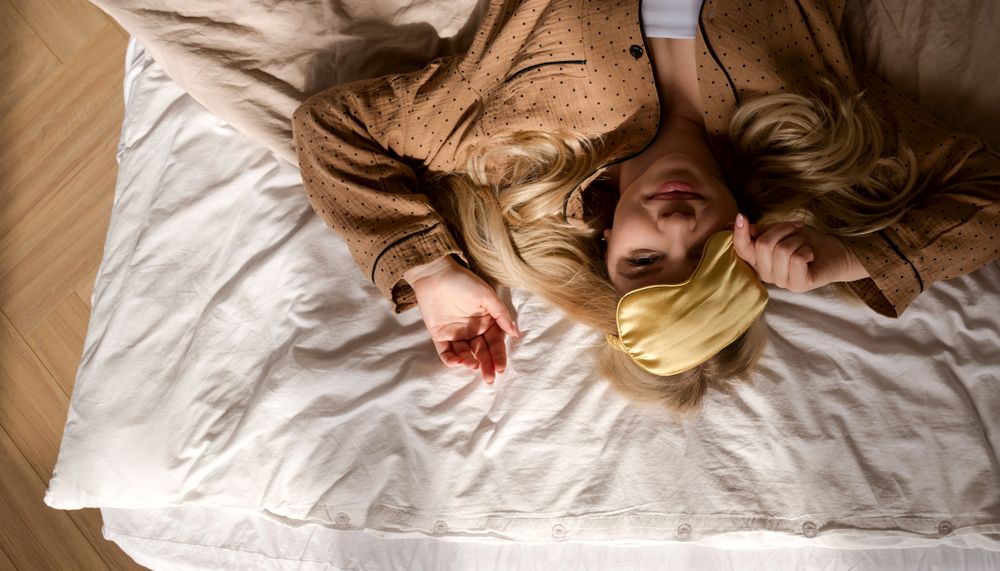 Overhead view of woman lying on bed