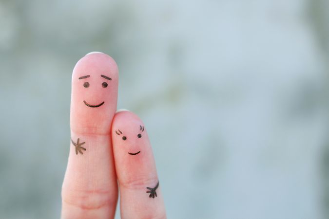 Fingers art of father hugs her daughter.