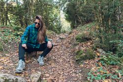 Stylish female teenager in casual outfit at autumn forest