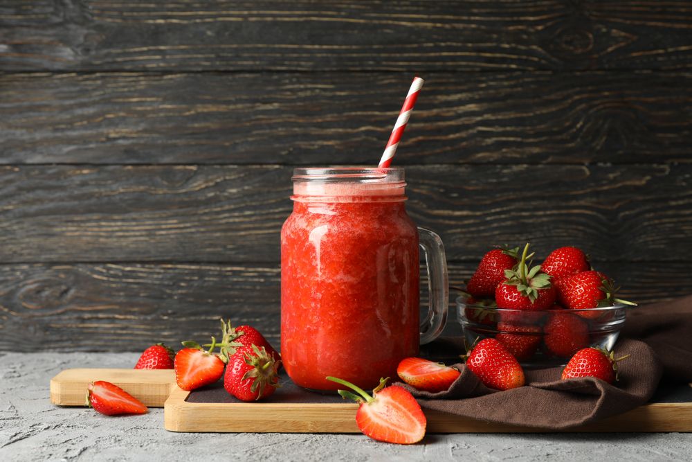 Composition with strawberry cocktail on gray table. Summer berry