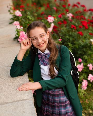 Young girl in school uniform smiling while resting