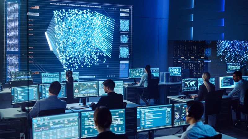 In a High-tech Command Center, Professionals Analyze Complex Data on Multiple Screens, Focusing on a Large Digital Display Showcasing Intricate Neural Network Patterns for Strategic Insights.