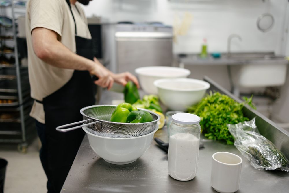 Chef cutting peppers in a kitchen