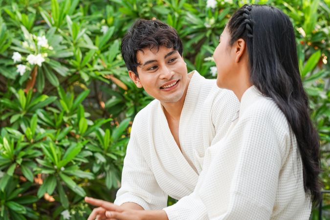Asian couple talking in bathrobes outside