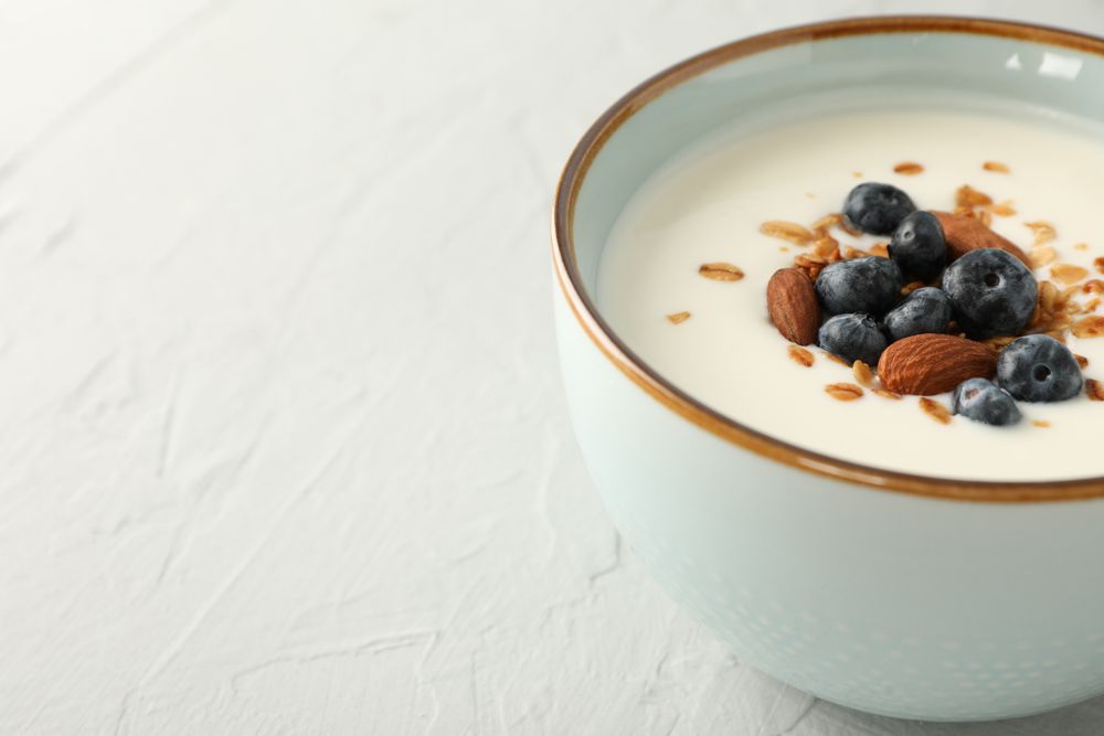 Bowl with parfaits dessert on cement background