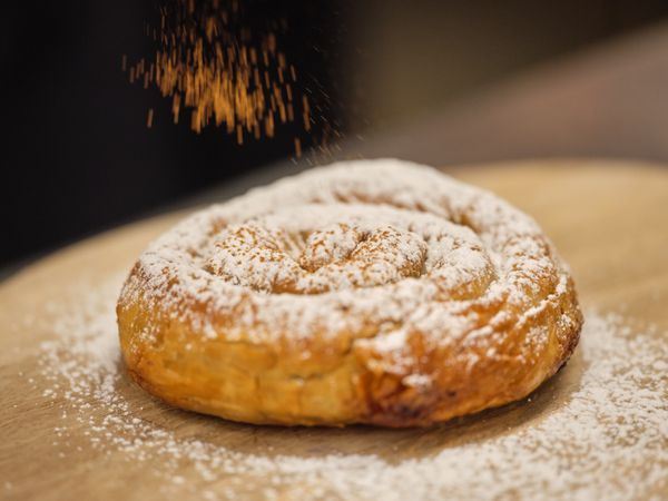 Served dough with cinnamon on wooden table