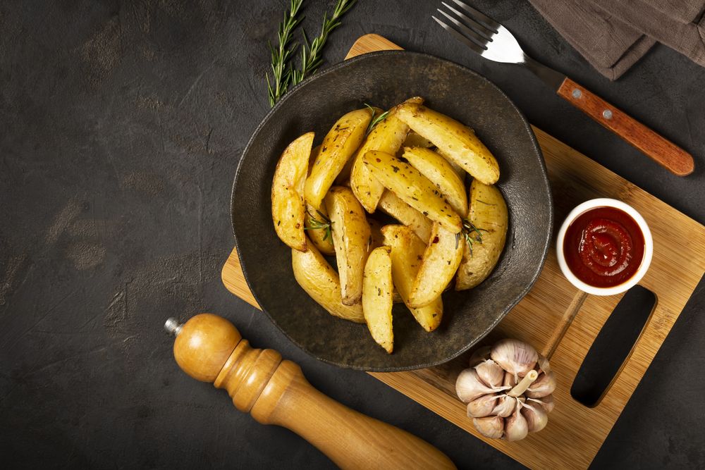 Roasted potatoes with rosemary on the plate.