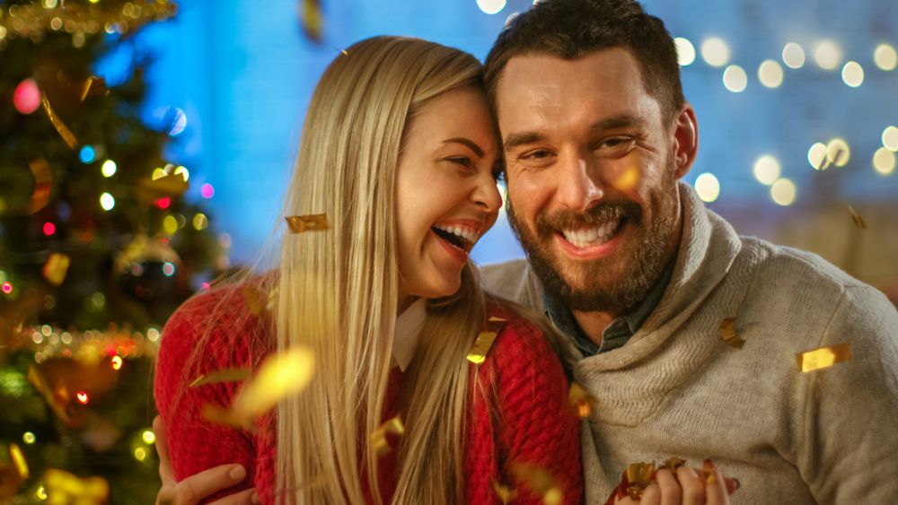 On Christmas Eve Man and Woman Embracing and Smiling.