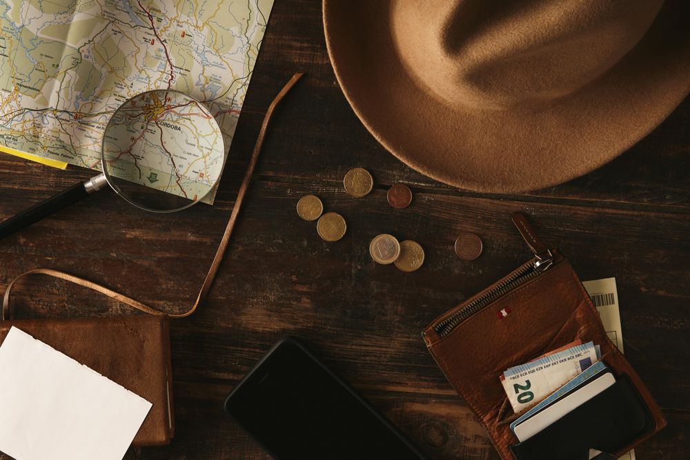 Top view aged table with travel accessories to plan adventure route