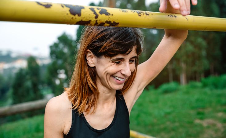 Happy and tired athlete woman after training