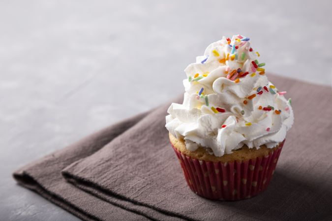 Tasty party cupcakes on the table. Cupcakes with whipped cream.