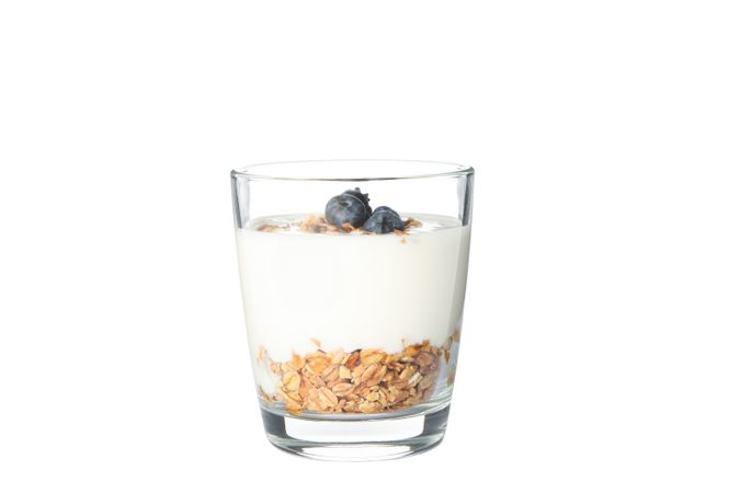 Parfait dessert in glass isolated on light background