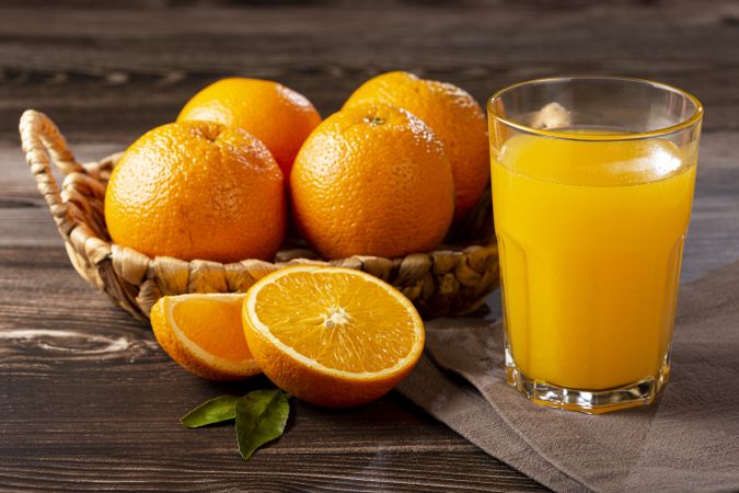 Glass with orange juice on the table.