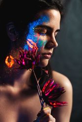 Young woman covered with uv painting