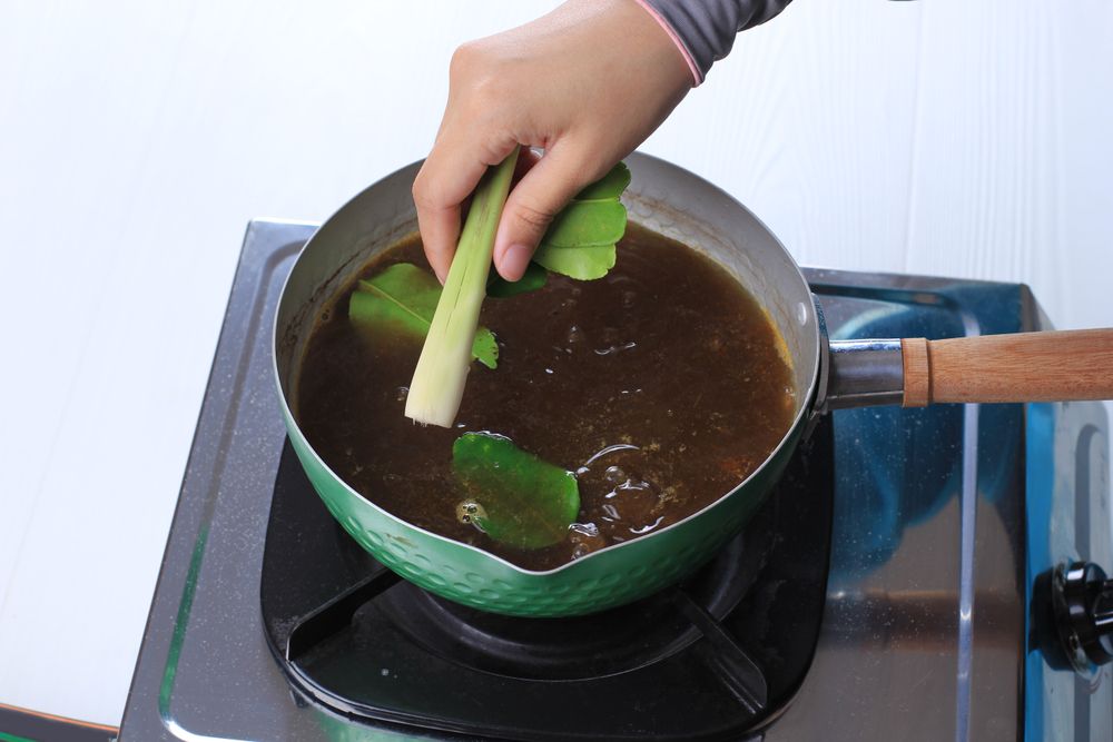 Person making pot of soup