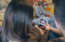 Parents looking at ultrasound of their new baby