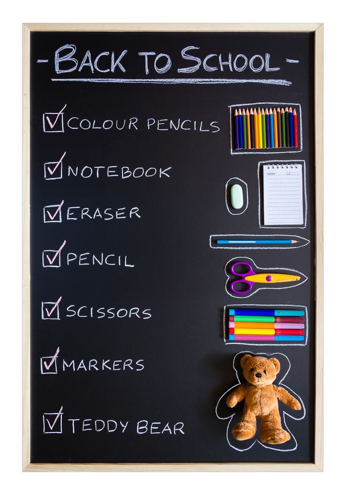School supplies over chalkboard background