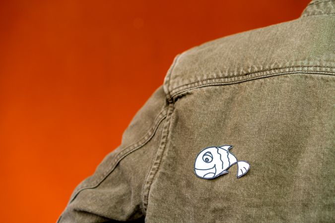 man with funny paper toy on jean jacket
