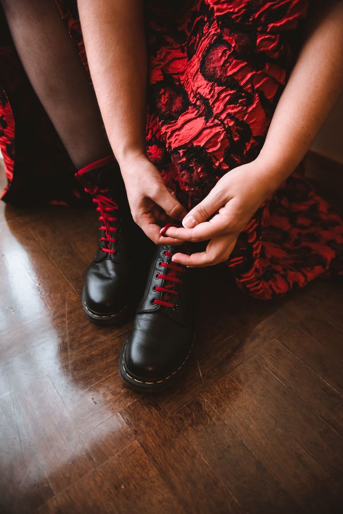 Woman in dress lacing boots