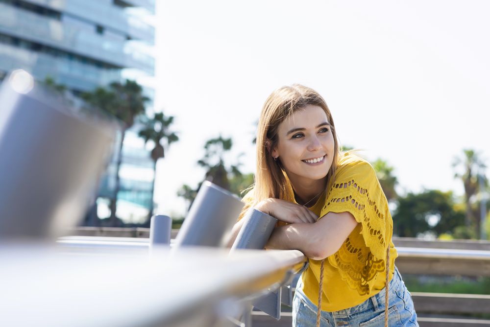Young woman leaning handrail