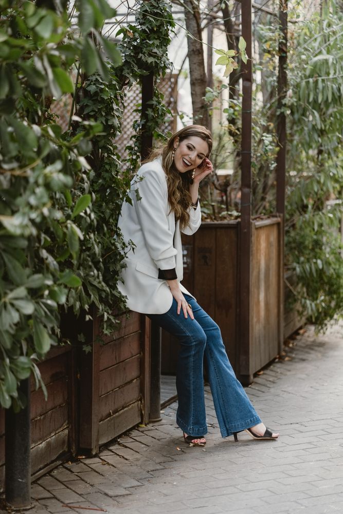 Woman sitting on planter in garden