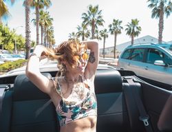 Young woman riding cabriolet