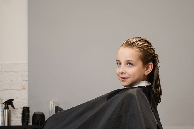 Child before haircut in beauty salon