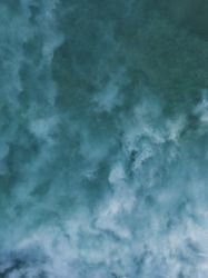 Aerial drone shot above murky ocean water
