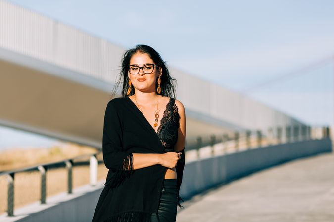 Trendy female standing on urban background