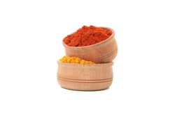 Side view of two wooden bowl full of different spices
