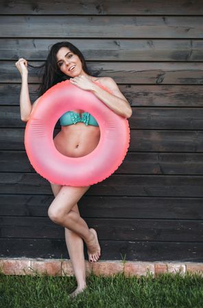 Woman in bikini holding swimming ring