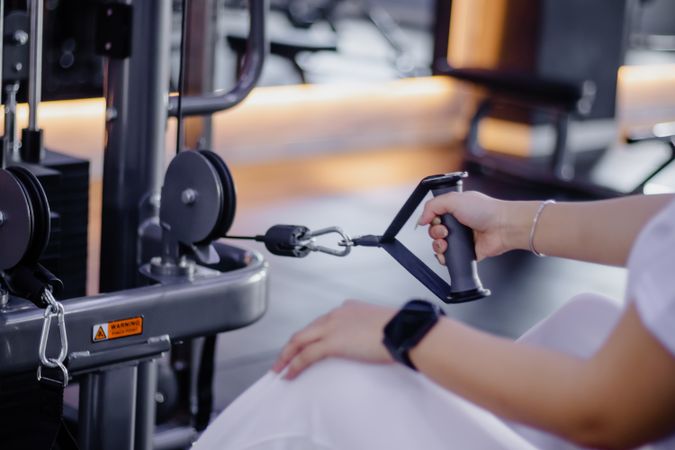 Woman Engaged in Cable Pulldown Exercise at Modern Fitness Cente