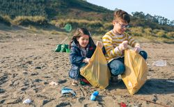 Children volunteers cleaning the beach