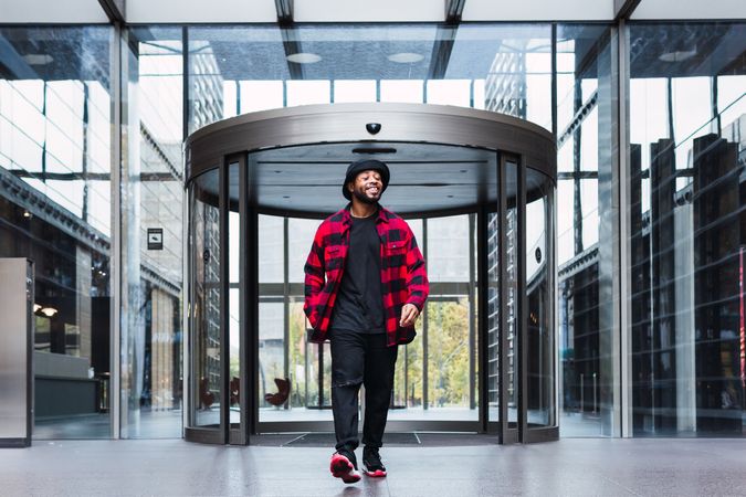Man near glass building entrance