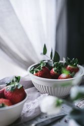 Strawberries and flowers on marble table