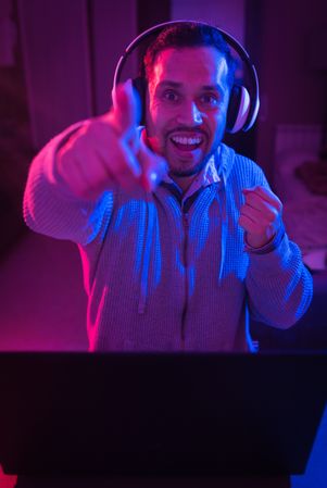 Man listening cheerfully to music with headphones.