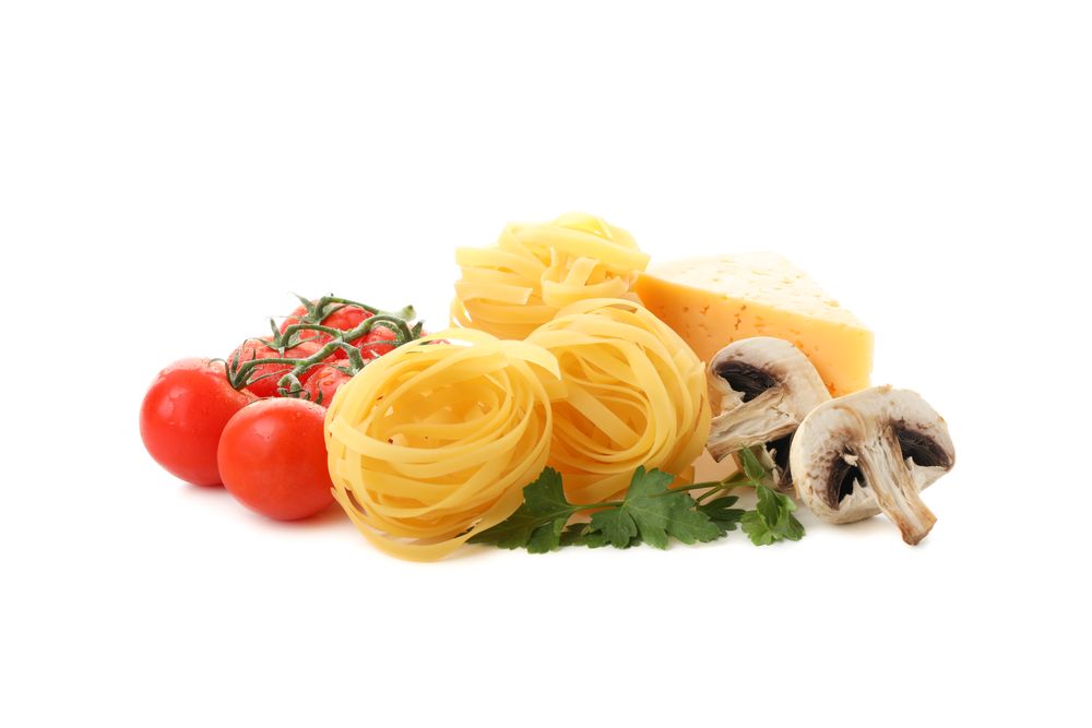 Tasty pasta and ingredients isolated on plain background