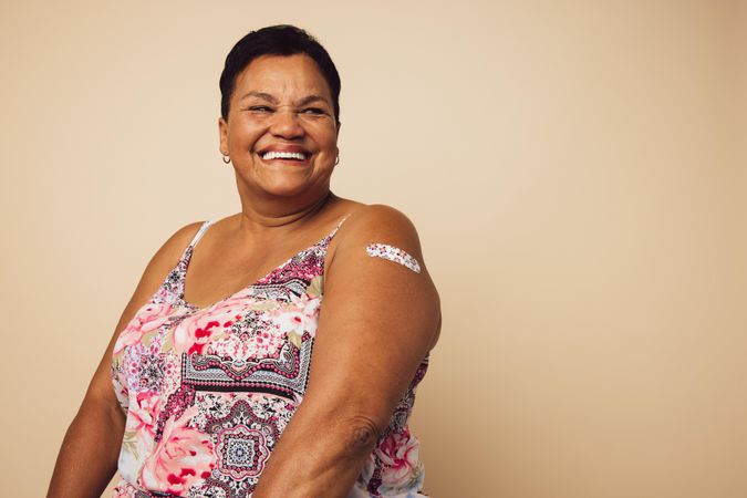 Portrait of a mature female smiling after getting a vaccine